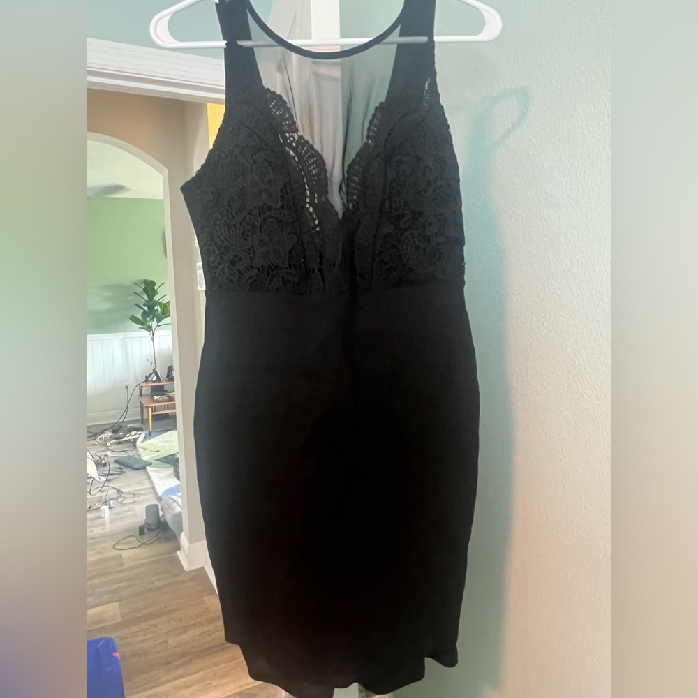 Black bandage dress with lace detail around the neck